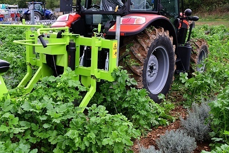 Tractor with agricultural machinery seen in a field during the Tech et Bio international agricultural fai. welcome sign