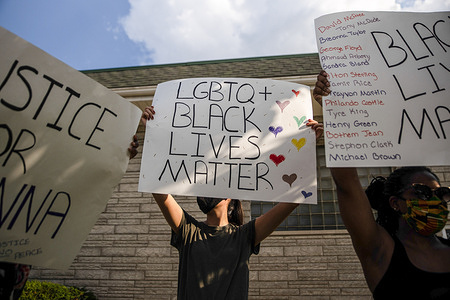 Protesters hold placards during a peaceful demonstration.
Families support the black lives matter movement at a peaceful protest organised for families and kids in the wake of George Floyd's murder. For most protesters, this was the first event they felt comfortable attending with their children as other protests have been violent.