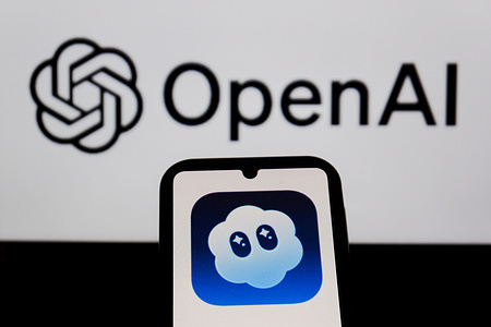 In this photo illustration, Sora AI logo is displayed on a smartphone and in the background.