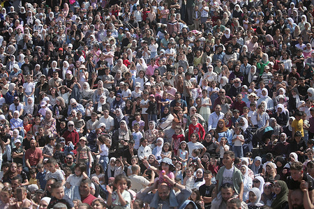 Palestinian crowds participate in celebrations marking the final day of Eid al-Adha in Nablus, West Bank. Thousands of Palestinians gathered in Jamal Abdel Nasser Square to celebrate the Islamic holiday.