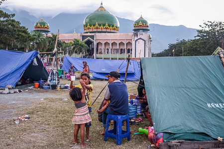 Refugees seen set up tents in the Lere Refugee settlement.
A deadly earthquake measuring 7.7 magnitude and the tsunami wave caused by it has destroyed the city of Palu and much of the area in Central Sulawesi. According to the officials, death toll from devastating quake and tsunami rises to 1,347, around 800 people in hospitals are seriously injured and some 62,000 people have been displaced in 24 camps around the region.