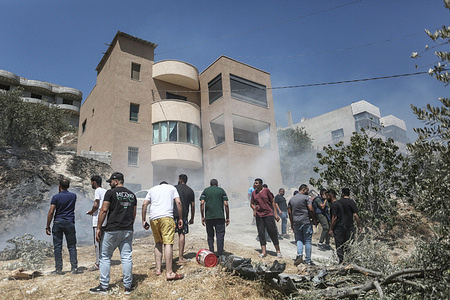 Palestinians inspect the site that was blown up by an explosive device detonated by Israeli forces in the village of Kafr Qalil during a military operation. The forces detonated the device and arrested five Palestinians during the operation.