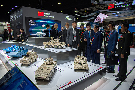 Visitors inspect a model of the military vehicles at a Norinco booth during the exhibition. The Defense and Security 2023 exhibition was held at the IMPACT Muang Thong Thani, Nonthaburi province. The four-day exhibition showcases new military weapons, equipment, technology and products for land, sea and air defense, and internal security.