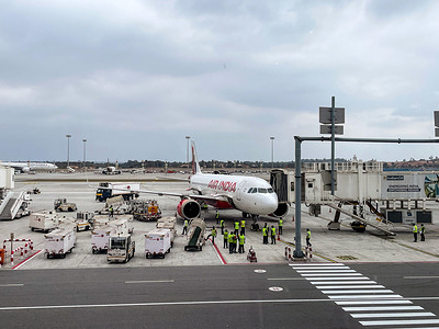 Air India Express aircraft sits on the tarmac as ground staff prepare the plane after landing at Kempegowda International Airport. Kempegowda International Airport Bengaluru targets expanded international connectivity and capacity in 2026 after passenger traffic climbed to 43.82 million in 2025.