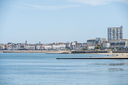 Margate seafront from distance with the beach and the Arlington House. Margate is a seaside town on the Isle of Thanet in Kent, England. It is located on the north coast of Kent. It is famous and popular for its sandy beach and the beautiful seafront.
