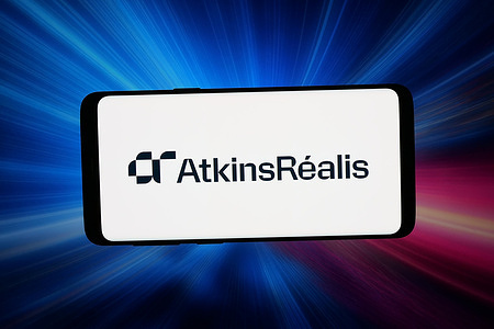 In this photo illustration, the logo of Canadian company AtkinsRealis Group Inc. is seen displayed on a smartphone in front of an abstract background on a computer screen.