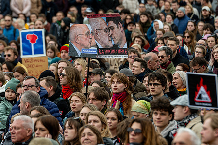 Demonstrators hold flags and political placards during the protest rally in Vilnius. A protest rally titled "Hands Off Freedom of Speech" took place on Cathedral Square in Vilnius, Lithuania. The event opposed proposed amendments to the law on public broadcaster LRT, which organizers viewed as threats to media independence. Lithuanian media estimated attendance at least 25,000 people, based on mobile device data.