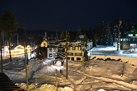 Visitors walk through the snow covered road at the world famous Gulmarg ski-resort, about 55kms from Srinagar, the summer capital of Jammu and Kashmir. Gulmarg, situated in the foothills of the Himalayas at 2,745 meters (9,000 feet) above sea level, is regarded as one of the leading ski destinations in South Asia.
