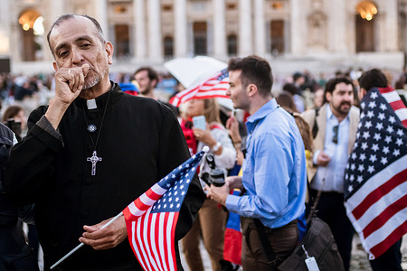A priest seen holding an American flag. American born Cardinal Robert Francis Prevost (69 years) was elected as 267th Bishop of Rome and Head of the Catholic Church with the name of Pope Leo XIV by 132 Cardinals gathered in the Conclave.