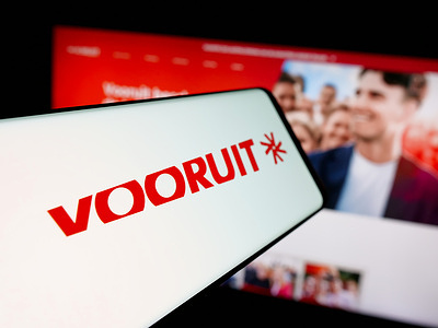 In this photo illustration, a smartphone with the logo of Flemish political party Vooruit is seen on screen in front of website.