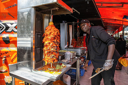 A man sells grilled chicken on the streets in Nairobi.