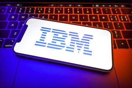 In this photo illustration, an International Business Machines (IBM) logo is displayed on the screen of a smartphone.