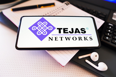 In this photo illustration, the Tejas Networks logo is displayed on a smartphone screen.