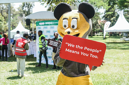 A mascot poses for a photograph while holding a poster during a continuous voter registration drive by Kenya’s Independent Electoral and Boundaries Commission (IEBC) at a concert in Nyayo Garden, Nakuru City. A rallying call urged young people frustrated by corruption, rising unemployment, and the high cost of living to register as voters and make their voices heard ahead of the 2027 general election.