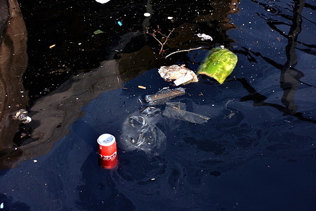 Plastic waste float on dirty water of the Old Port of Marseille.