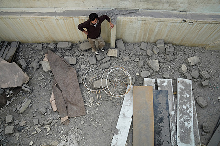 A Iraqi man inspects his damaged home following a drone strike in the city of Erbil, the capital of Iraq’s Kurdistan region.