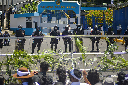 Riot control police officers guard the main entrance into the Salvadoran Legislative Assembly during the demonstration.
Members of churches and social movements took to the streets to protest for the environment, the Salvadoran Congress archived hundreds of law projects including several proposals for the environment and water as a human right.