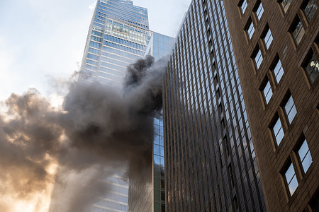 Fire and smoke billows from the upper floors of a high-rise building under construction on east 43rd Street on March 17, 2026 in New York City.