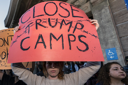 A woman holds a sign that says Close Trump Camps during a rally in protest of the Trump Administration's plan to use the Fort Sill Army Base as a detention center for immigrant children and other Immigration Customs Enforcement (ICE) detainees. Los Angeles, California. Organizers called to end family separation policies. During World War II, Fort Sill served as a Japanese American internment camp. The rally took place outside the Japanese American National Museum.