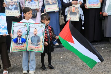 A young girl seen holding a photograph of her brothers detained in Israeli prisons while the other holding a Palestinian flag during the protest. Families gathered holding photos of their loved ones and calling on the International Committee of the Red Cross, human rights organizations and civil society to intervene and address the suffering of prisoners within Israeli prisons.
