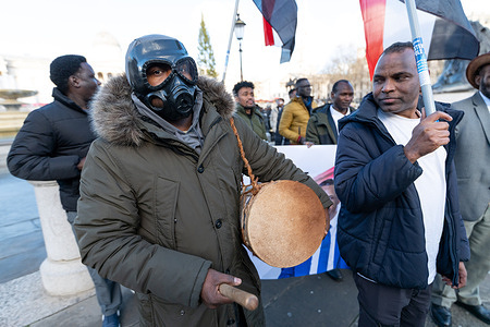 A man seen wearing a gas mask during the rally. Sudanese protesters gathered in Trafalgar Square to condemn the use of chemical weapons by the Sudanese Armed Forces, calling for international accountability and protection for civilians.