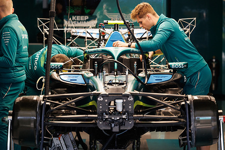 Mechanics work on the Aston Martin Aramco Formula One Team AMR26 in the garage ahead of the F1 Grand Prix of Japan at the Suzuka Circuit