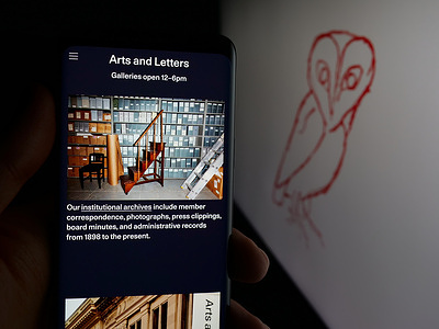 In this photo illustration, a person is holding a smartphone with the web page of society American Academy of Arts and Letters on screen in front of logo.