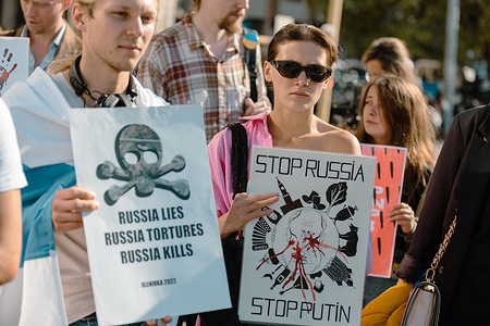 A female protester holds a placard that says "Stop Russia, Stop Putin" during an anti-war and anti-referendum protest against the Russian invasion of Ukraine. After seven months of Russia's invasion, it has organized and started a referendum in four eastern regions of Ukraine on September 23, 2022, in Kherson, Zaporizhzhia, Donetsk, and Lugansk. Western nations have denounced the referendums in Russia-controlled regions as "shams".