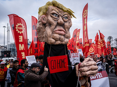 Members of the Labor Party are seen carrying a cardboard statue of Donald Trump during an anti-NATO protest. A large number of people gathered in Istanbul for a demonstration held on the anniversary of NATO's founding. The crowd, which assembled in front of the AKM (Atatürk Cultural Center), marched to Dolmabahçe Palace, calling for the dissolution of NATO and Turkey's withdrawal from the alliance.
