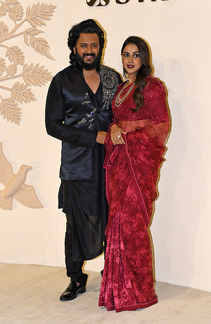 Bollywood actor and actress Riteish Deshmukh and Genelia D'Souza pose for a photo as they arrive for a special celebration in honour of India's master artisans taking centre stage hosted by Indian businesswoman and philanthropist Nita Ambani at her flagship store Swadesh. Swadesh store founded by Indian businesswoman and philanthropist Nita Ambani aims to promote and preserve Indian craftsmanship and provide a platform for artisans. The focus is on luxury ethnic handicrafts, textiles and decor and to create sustainable livelihood opportunities for craftspeople.