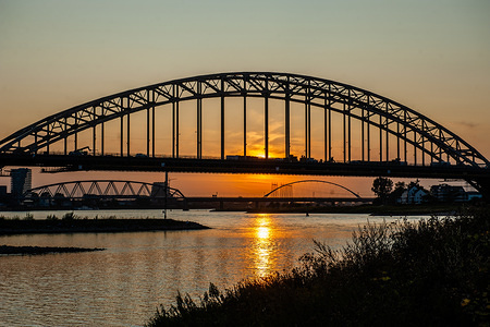 View of the Waalbrug bridge during sunset.
The Ooijpolder is a beautiful area for walking and recreation close to the Waalbrug Bridge and surrounded by the Waal River. The area is located east of the city of Nijmegen in the province of Gelderland.