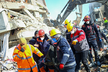 (EDITORS NOTE: Image depicts death)
A search and rescue team carries a corpse removed from the ruins. Hatay is one of the areas most affected by the earthquake in southern Turkey, which measured 7.8 on the Richter scale and was one of the worst to hit the country is almost a century. A second quake also struck northern Syria and was measured at 7.7.