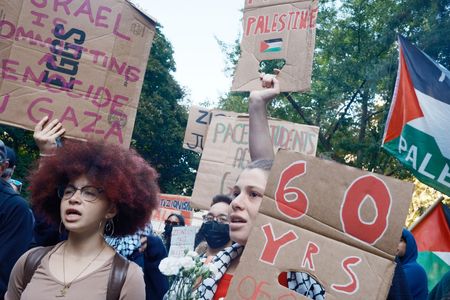 Hundreds of PACE University students seen holding signs while marching past City Hall to Union Square marking the third anniversary of the October 7th Hamas ambush attacks . Pro- Palestinian student groups protested and marched throughout New York City.