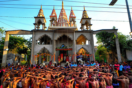 Hindu devotees seen praying to their almighty before taking part in the annual Gajan Festival at ShivaTemple of Murshidabad. Gajan is a Hindu festival celebrated mostly in the rural part of West Bengal. The festival is related to Lord Shiva and as per Mythology on the last day of Bengali Calendar (Middle of April) devotees used to worship dead bodies to satisfy Lord Shiva for better rain and harvest. The central theme of this festival is deriving satisfaction through non-sexual pain, devotion and sacrifice.