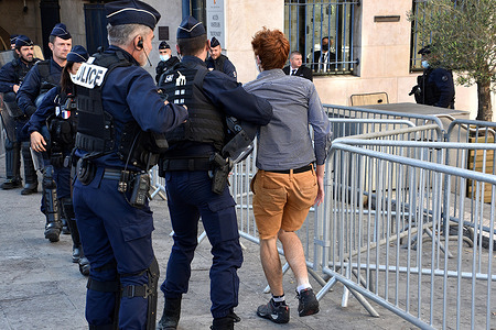 Police officer arrests a protester during the demonstration.
Called by French unions Workers' Force (Force Ouvriere / FO), French Democratic Confederation of Labour (Confederation Francaise Democratique du Travail / CFDT) and Sud Rail (Solidaires Unitaires Democratiques), SNCF workers took part in a demonstration ahead of the vote of the Provence-Alpes-Cote d’Azur (PACA) regional assembly which will decide who will operate the Regional Express Train (TER) line between Marseille and Nice. The French private rail operator Transdev is excepted to take over the train line.