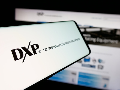 In this photo illustration, a smartphone with the logo of US distribution company DXP Enterprises Inc. is seen on screen in front of website.
