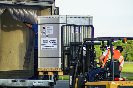 Airport workers transport COVID-19 vaccine doses.El Salvador received more than 500,000 vaccines from Chinese manufacturer Sinopharm making it it's 32 arrival of COVID-19 vaccines.