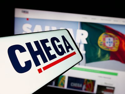 In this photo illustration, a smartphone with the logo of Portuguese political party Chega (CH) is seen on screen in front of website.