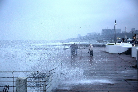 People walk along the promenade on Langeron beach where the waves crash. The last day of autumn 2025 in Odessa was rainy and windy. There was a slight storm at sea. The Hydrometeorological Center reports that similar weather will continue into early December.