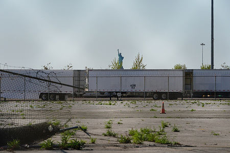 Refrigerator trucks being used as a temporary morgue at 39th St. Pier in Brooklyn borough.
New York City's Medical Examiner operating a long-term disaster morgue at Brooklyn's 39th St. Pier, where human remains will be kept inside freezer trucks, in an effort to provide relief to funeral directors overwhelmed by the COVID-19 crisis.