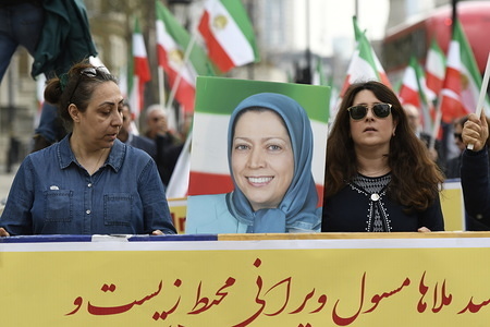 Protesters are seen carrying a placard with the photo of Ms Maryam Rajavi, president-elect of the Iranian Resistance. Members of the Anglo-Iranian communities and supporters of the National Council of Resistance of Iran (NCRI) gathered for a rally in London to express solidarity with flood victims in Iran and condemn the regime for mobilising the revolutionary Guard (IRGC) to confront the popular protests against the lack of relief.
