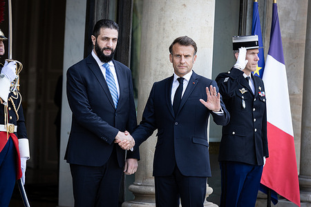 French President Emmanuel Macron (R) welcomes Ahmed al-Sharaa (L), Syria's Interim President, at the Elysee Presidential Palace during the meeting. The French President met with the Ahmed al-Sharaa, Syria's Interim President at the Elysee Presidential Palace, in Paris. This was the first visit of Ahmed al-Sharaa to a European country as leader of the transitional government, following the fall of the Assad regime in December.
