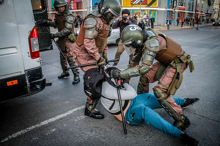 Police officers arrest a protester during a Commemorative march. Protesters took to the streets to commemorate the Social Outburst that occurred in Chile three years ago on October 18, 2019 which was one of the most critical moments in politics and a show of social discontent due to exploitation of different kinds. This year there was again police repression towards the protesters in the confrontation against the new government of Gabriel Boric.