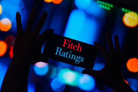 In this photo illustration, the Fitch Ratings logo is displayed on a smartphone screen.