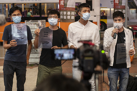 Pro-democracy activists Eddie Chu (L), Joshua Wong (L2), Owen Chow (R2), and Lester Shum (R) distribute leaflets while talking to the press in support of the 12 activists detained in Mainland China during the rally.
Pro democracy activists rally in Hong Kong in support of the 12 Hongkongers detained in Mainland China after allegedly trying to flee to Taiwan to claim political asylum in August 2020. The 12 detainees has committed different political crimes in Hong Kong and were on court bail when they fled.