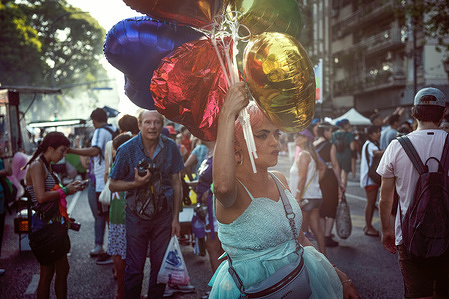 A woman holds balloons during the International Women's Day rally. Thousands of people attended the rally to support women's rights on International Women's Day in Buenos Aires, Argentina.