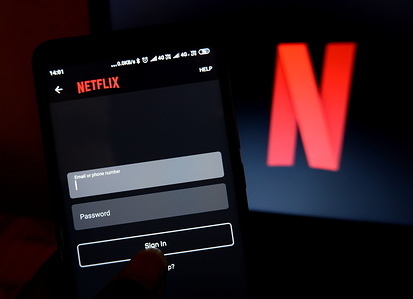 In this photo illustration a popular Movie & video on demand application Netflix logo seen displayed on a smartphone.