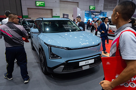 Visitors inspect a KIA EV5 car during the Thailand Big Motor Sale 2025 at Bangkok International Trade and Exhibition Center (BITEC).