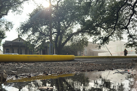 A New Orleans firefighter works to extinguish a two-alarm house fire in the 900 block of Louisiana Avenue. According to a report, firefighters with the New Orleans Fire Department responded to the incident. No other details are available at this time, such as the cause of the fire, whether there were any injuries, or the extent of the damage.
