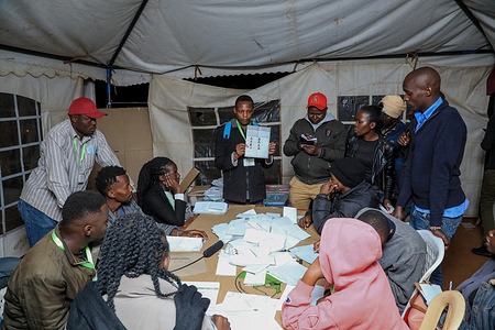 An election official counts presidential votes at Kibera DC Grounds polling station. Kenyans on August 9, 2022 went to the ballot to vote for a new president with the candidates being 77 year old Raila Odinga who vied on Azimio la Umoja One Kenya alliance and 55 year old William Ruto United Democratic Alliance party (UDA). Accord to local media reports (Citizen Digital), William Ruto is leading with 1,719, 510 and Raila Odinga 1,660,116.